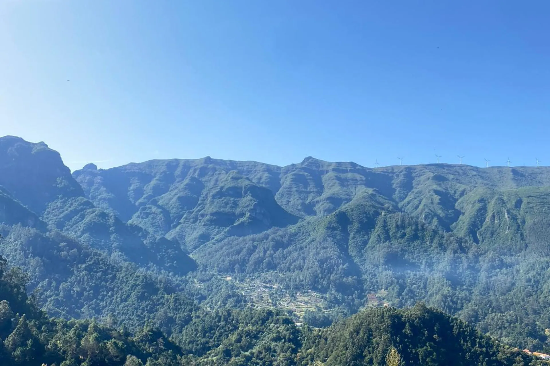 Forested ridges of the central massif with wind turbines on the skyline